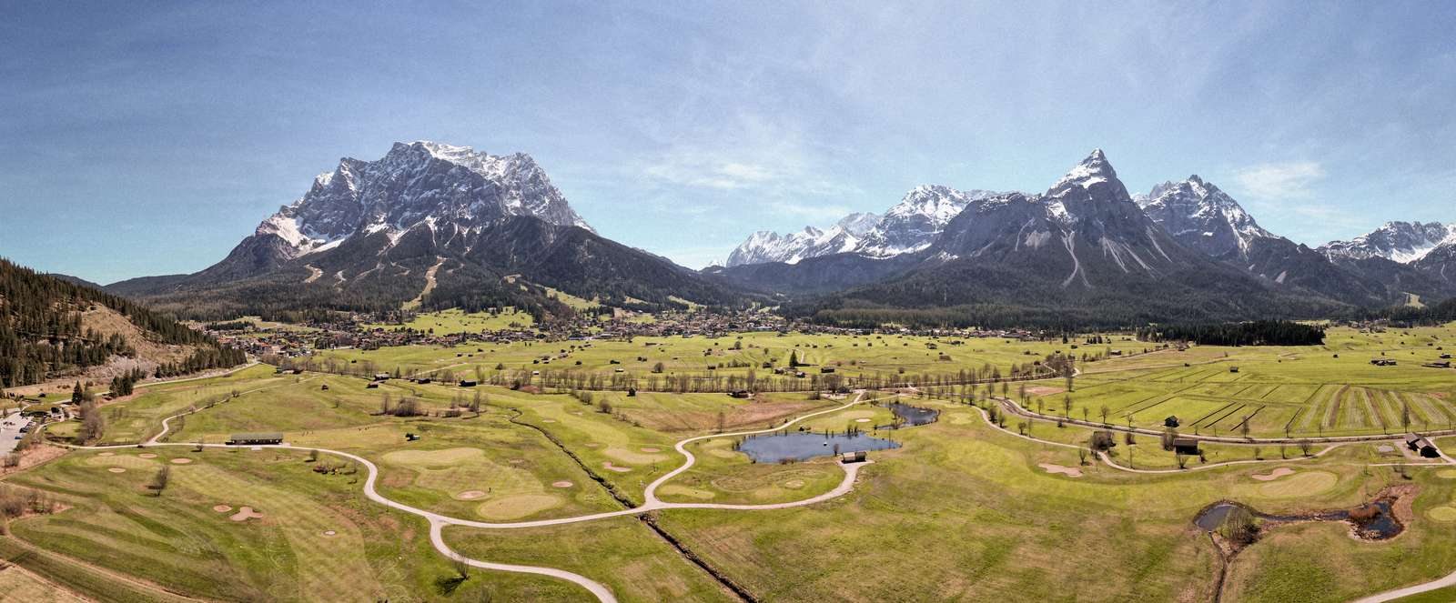 View of the golf course and the Moos, with the Wetterstein mountains and the Sonnenspitze in the background